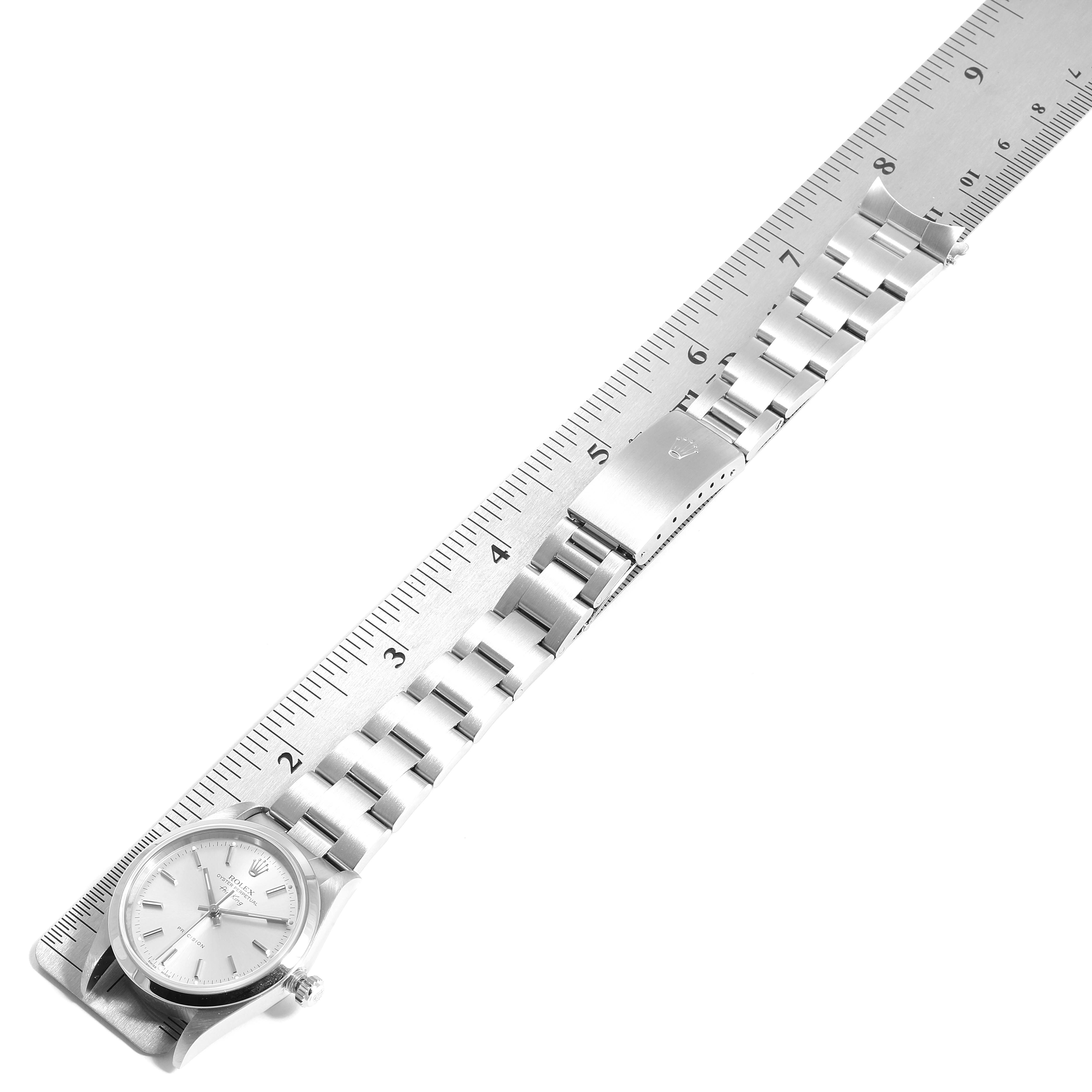 The Rolex Air-King 14000 Men's Stainless Steel Silver Dial 14000 Men's Stainless Steel Silver Dial watch is shown lying flat with its case and bracelet visible, aligned along a ruler for measurement.
