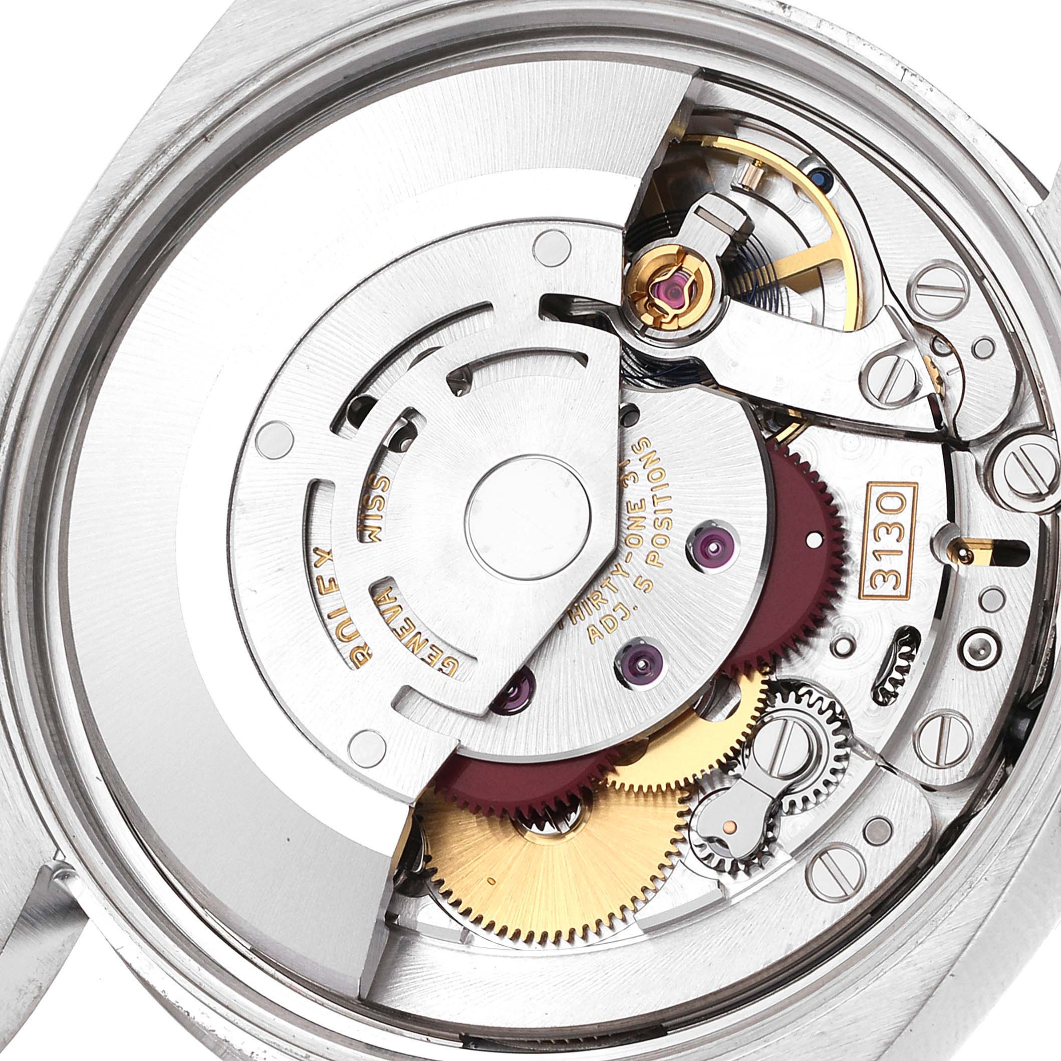 The image shows a close-up view of the internal mechanics of a Rolex Oyster Perpetual 114200 Men's Stainless Steel Blue Dial 114200 Men's Stainless Steel Blue Dial watch.