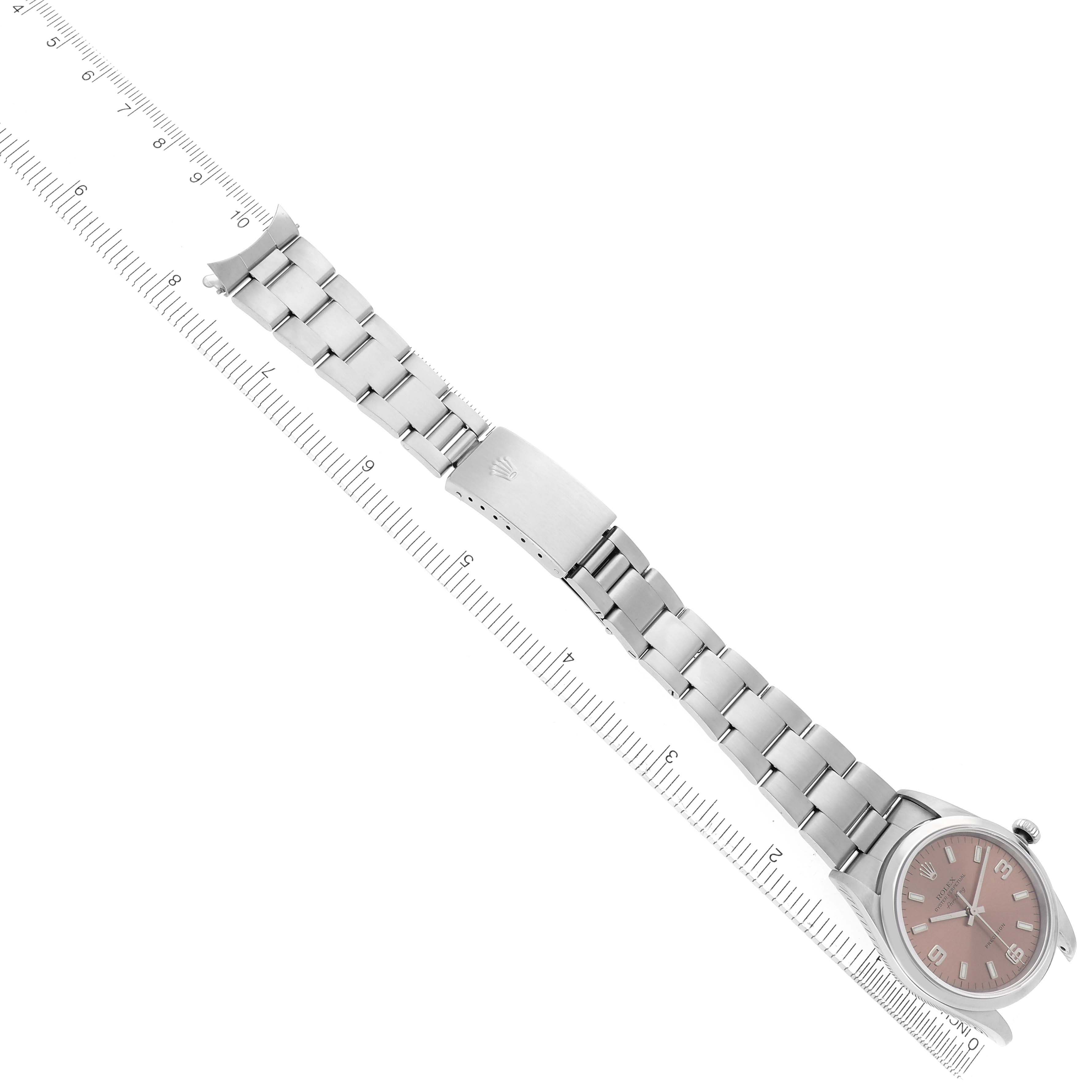 The Rolex Air-King 14000 Men's Stainless Steel Pink Dial 14000 Men's Stainless Steel Pink Dial watch is shown at a top-down angle, displaying the full bracelet and clasp alongside a ruler for scale.