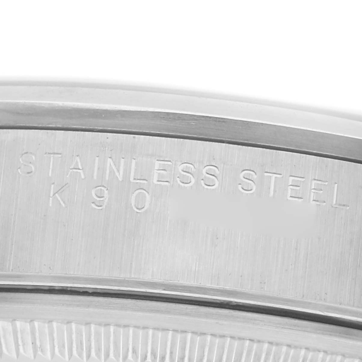 The image shows a close-up of the case back edge with "STAINLESS STEEL" engraved on the Rolex Air-King 14000 Men's Stainless Steel Pink Dial 14000 Men's Stainless Steel Pink Dial.