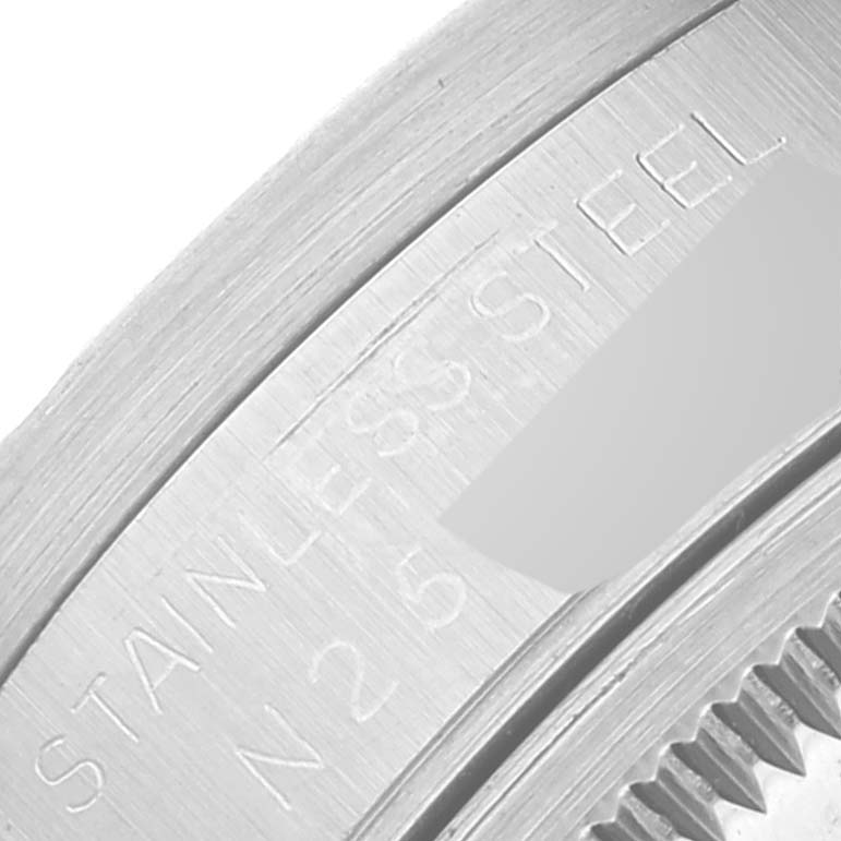 The image shows a close-up of the stainless steel case back and part of the ridged edge of a Rolex Date 15210 Men's Stainless Steel Black Dial 15210 Men's Stainless Steel Black Dial watch.
