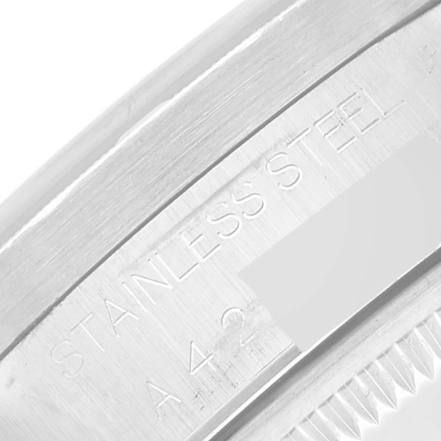 This is a close-up view of the stainless steel casing with engraved text on a Rolex Date 15210 Men's Stainless Steel Black Dial 15210 Men's Stainless Steel Black Dial model watch.