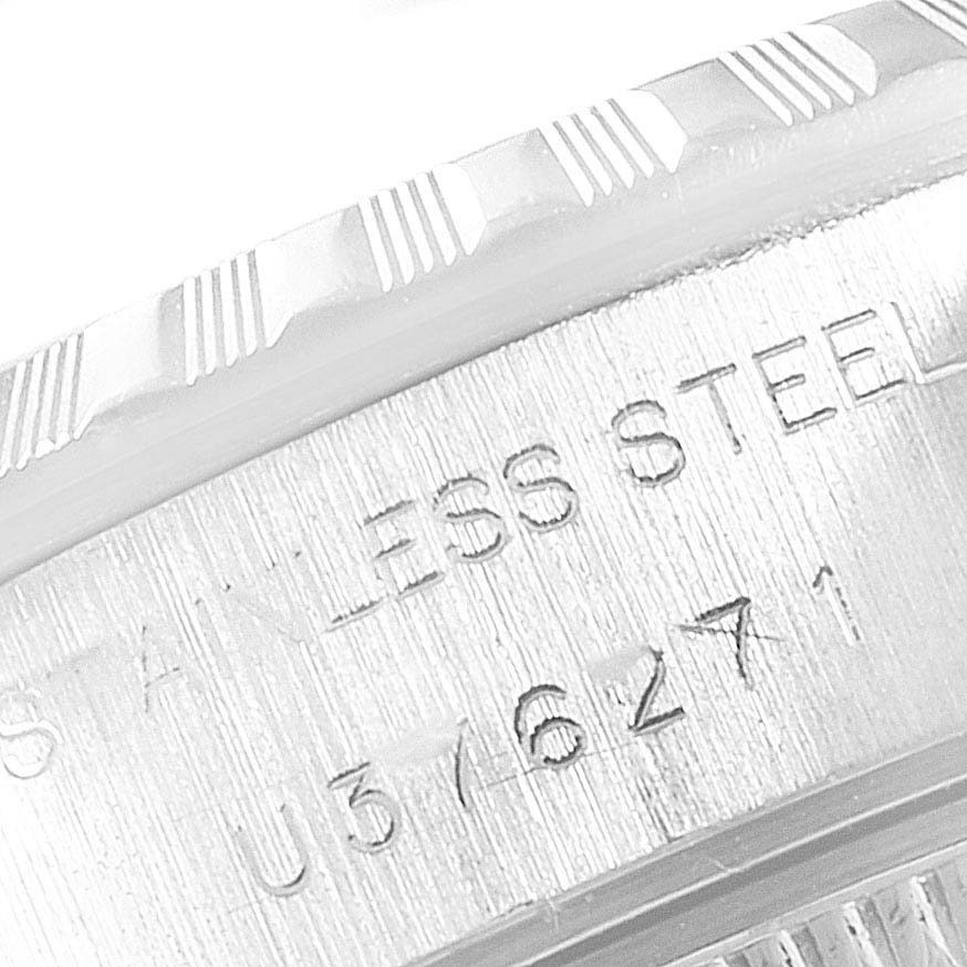 Close-up of the embossed text on the metal casing and bezel of a Rolex Datejust 69240  Women's Stainless Steel Blue Dial 69240  Women's Stainless Steel Blue Dial watch.