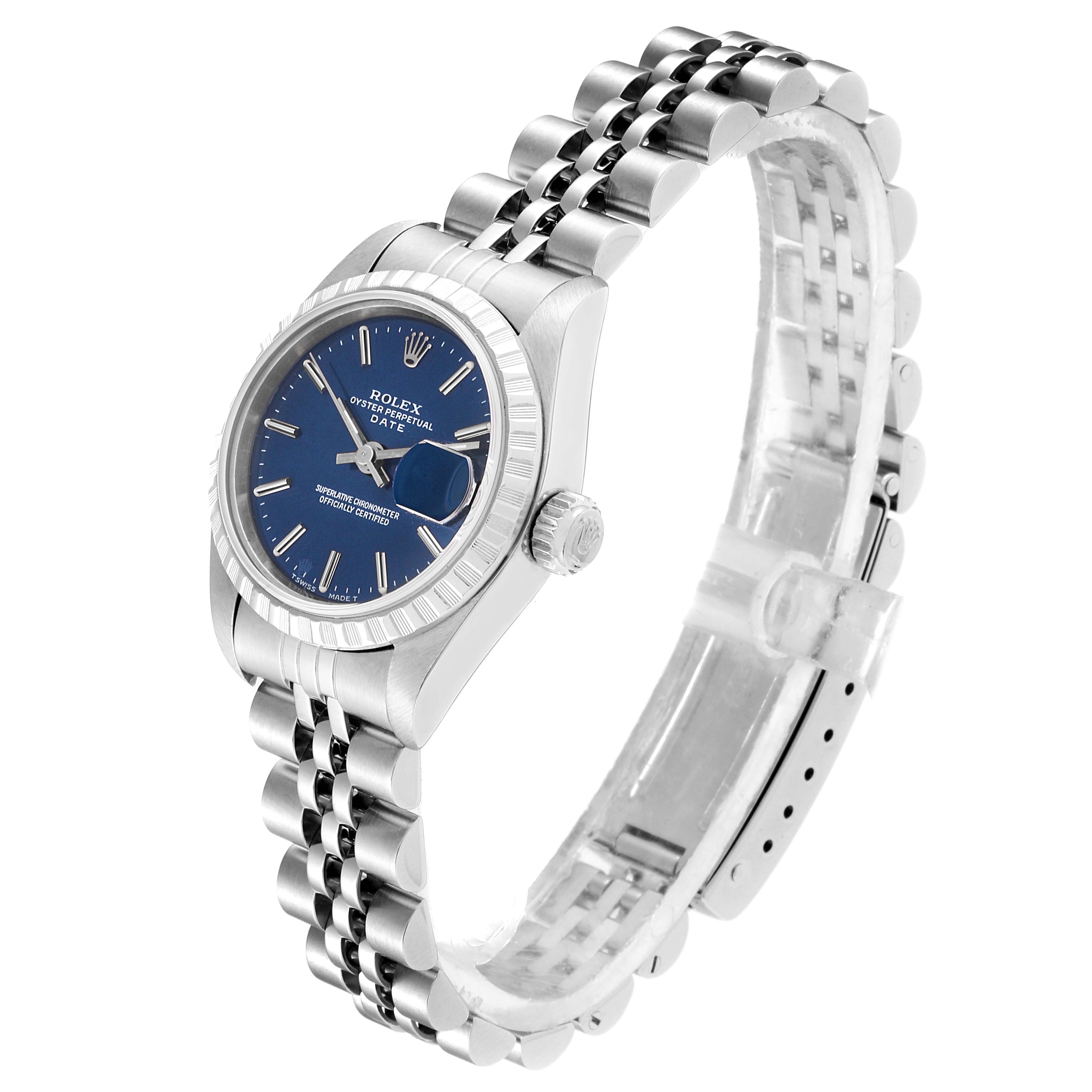 The image shows a side angle of a Rolex Datejust 69240  Women's Stainless Steel Blue Dial 69240  Women's Stainless Steel Blue Dial watch, highlighting its blue dial, fluted bezel, and Jubilee bracelet.