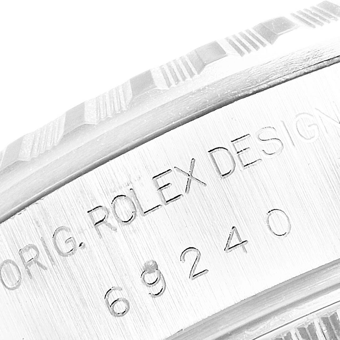 The image shows a close-up of the engravings on the side of a Rolex Datejust 69240  Women's Stainless Steel Blue Dial 69240  Women's Stainless Steel Blue Dial watch case.