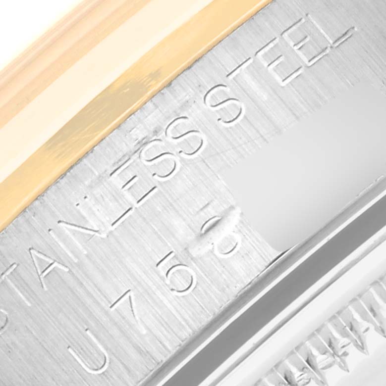 This image shows a close-up of the side of a Rolex Date 15203 Men's Steel and Gold (two tone) Champagne Dial 15203 Men's Steel and Gold (two tone) Champagne Dial model watch, specifically focusing on the stainless steel case and serial number.