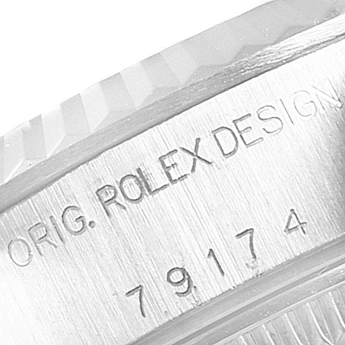 The image shows a close-up of the case engraving on the bezel of a Rolex Datejust 79174 Women's Stainless Steel Pink Dial 79174 Women's Stainless Steel Pink Dial watch.