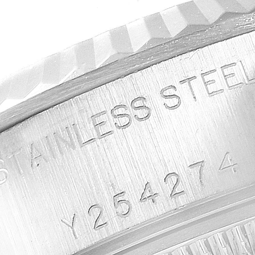 This image shows a close-up of the engraved serial number and part of the bezel on a Rolex Datejust 79174 Women's Stainless Steel Pink Dial 79174 Women's Stainless Steel Pink Dial model.