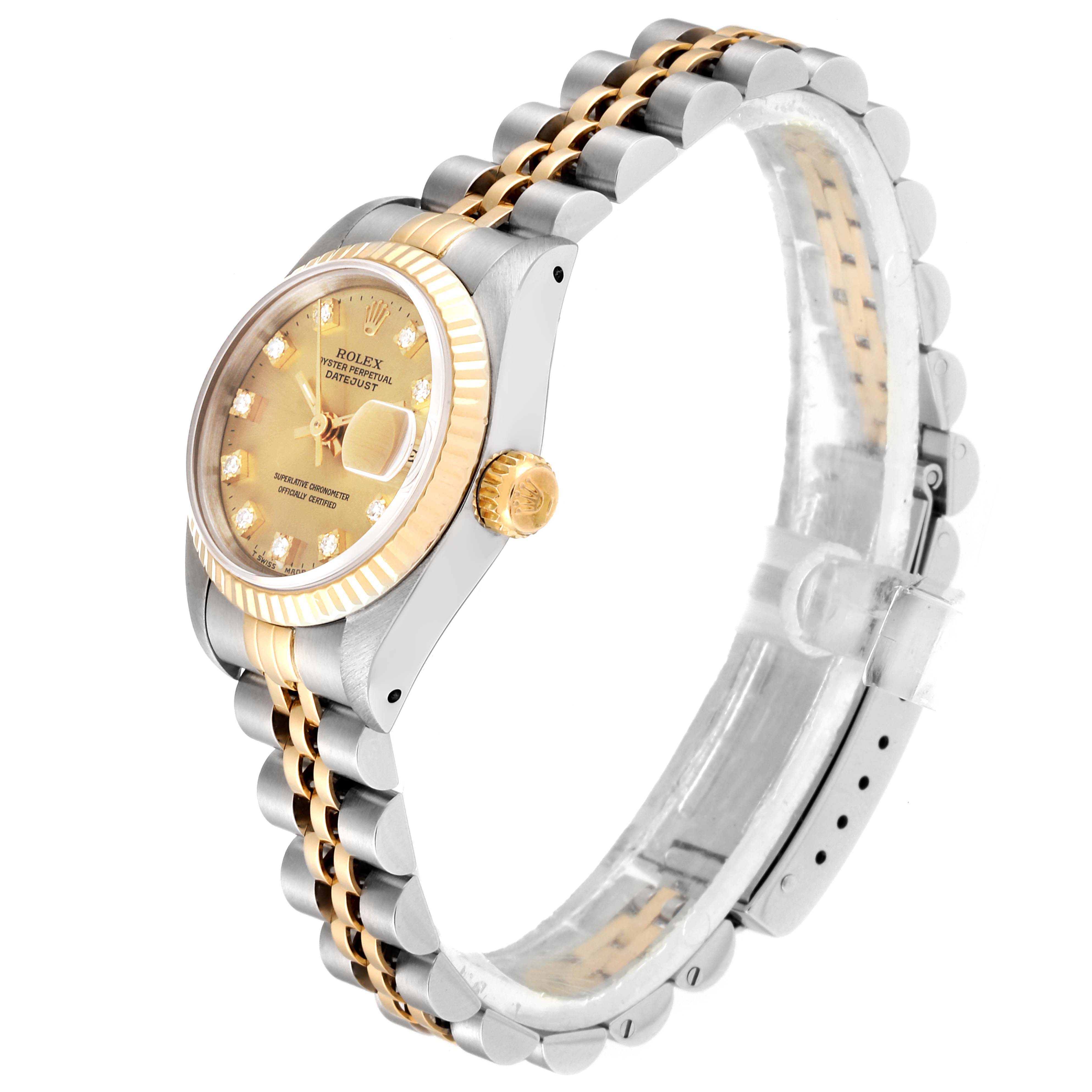 The image shows a side angle of a Rolex Datejust 69173 Women
s Steel and Gold (two tone) Champagne Dial 69173 Women
s Steel and Gold (two tone) Champagne Dial watch, highlighting its gold bezel, crown, and two-tone bracelet.