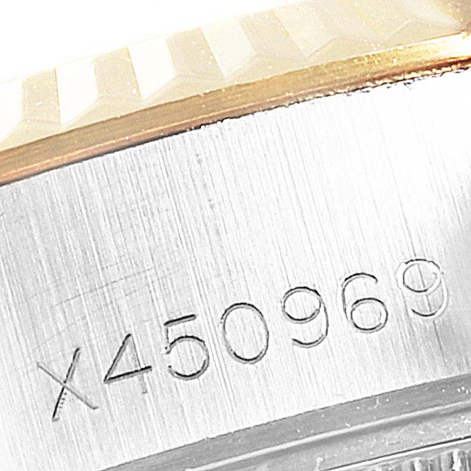 The image shows a close-up of the serial number engraving on the case side of a Rolex Datejust 69173 Women
s Steel and Gold (two tone) Champagne Dial 69173 Women
s Steel and Gold (two tone) Champagne Dial watch.