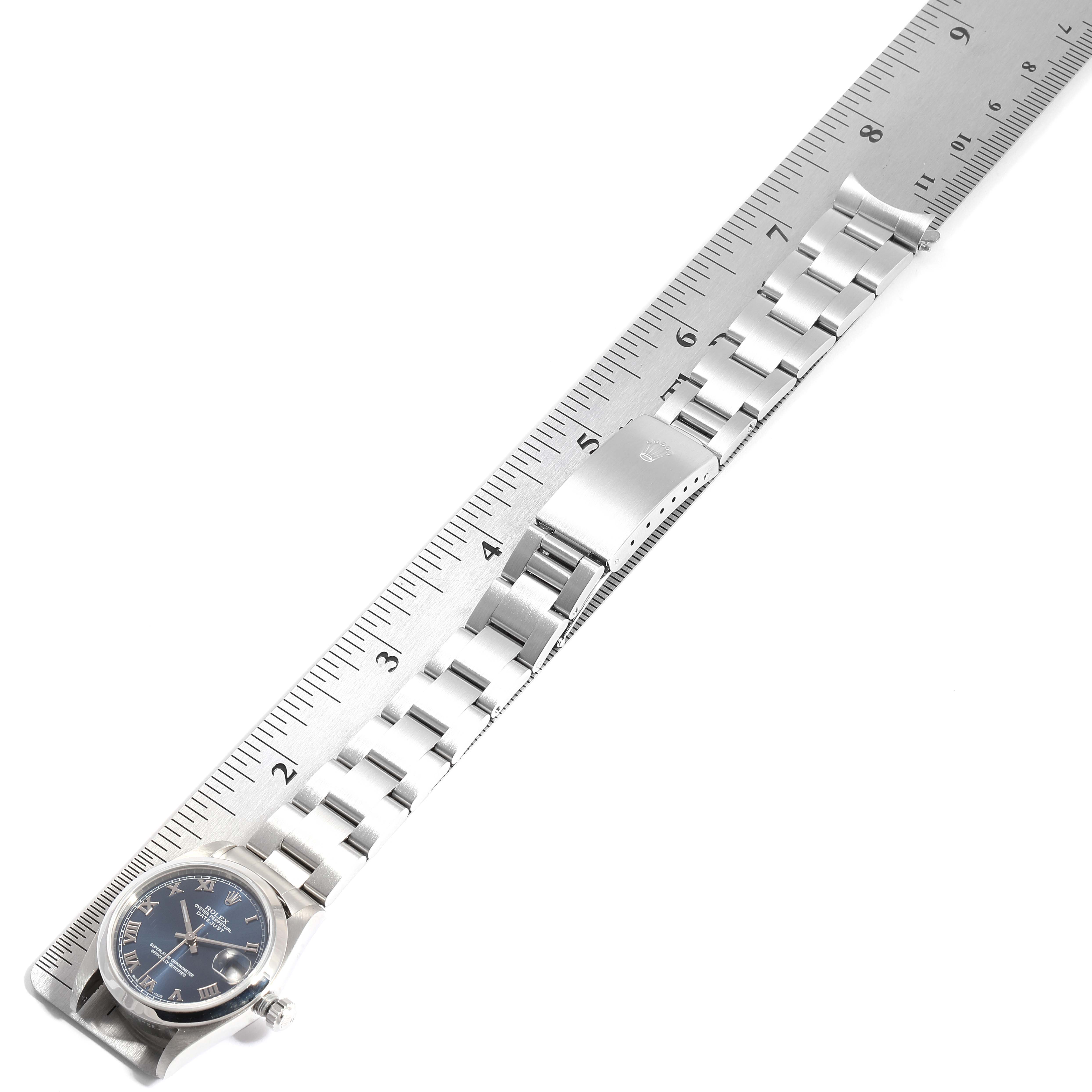 The image shows a side view of a Mid-Size Rolex watch and its linked metal bracelet, measured against a ruler.