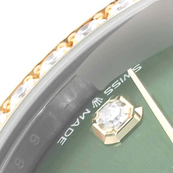 Close-up angle of a Rolex Mid-Size 278383 Women's Steel and Gold (two tone) Green Dial 278383 Women's Steel and Gold (two tone) Green Dial model showing part of the bezel with diamonds, the dial, and an hour marker.