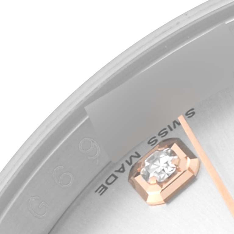 This close-up image of the Rolex Datejust 116231 Men's Steel and Gold (two tone) Silver Dial 116231 Men's Steel and Gold (two tone) Silver Dial watch showcases a portion of the dial with a diamond marker and "Swiss Made" text.