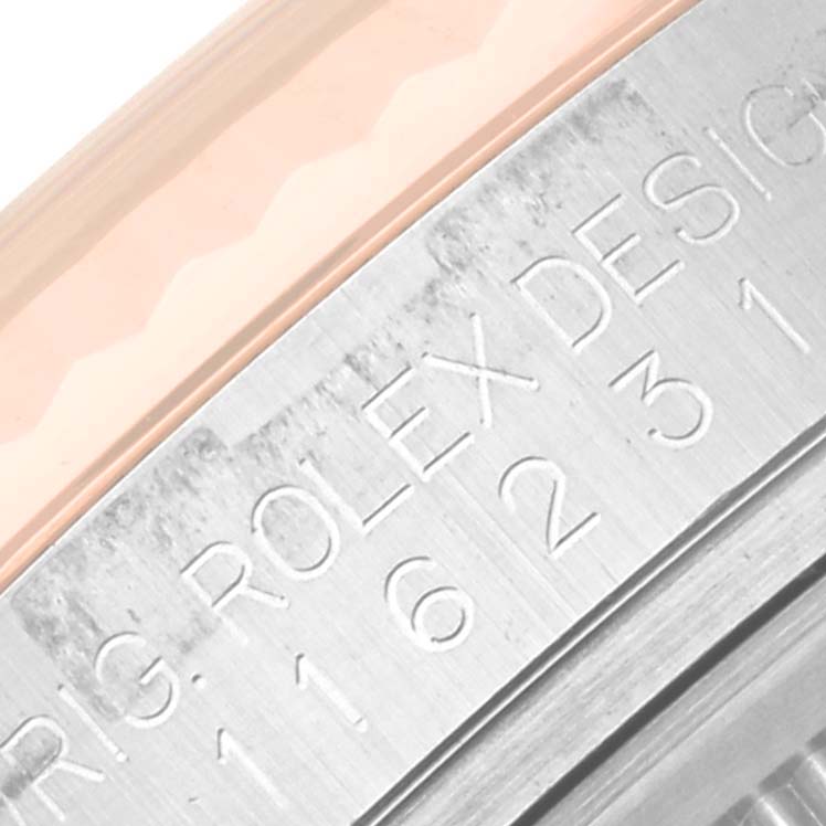 The image shows a close-up of the bezel and part of the casing with engravings of the Rolex Datejust 116231 Men's Steel and Gold (two tone) Silver Dial 116231 Men's Steel and Gold (two tone) Silver Dial watch.
