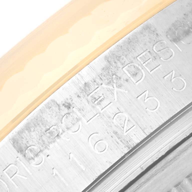 The image shows an angled close-up of the inner rim of the case with engravings for the Rolex Datejust 116233 Men's Steel and Gold (two tone) White Dial 116233 Men's Steel and Gold (two tone) White Dial watch.