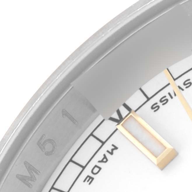 The image shows a close-up of the dial and part of the bezel of a Rolex Datejust 116233 Men's Steel and Gold (two tone) White Dial 116233 Men's Steel and Gold (two tone) White Dial watch, highlighting an hour marker and text details.