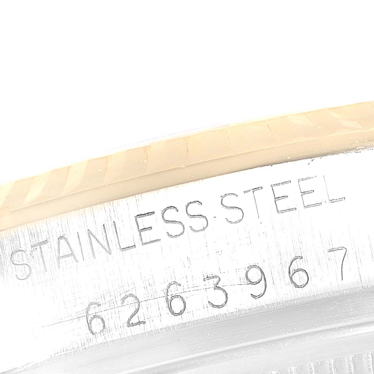 This image shows the side engraving of a Vintage Collection Rolex watch, highlighting "STAINLESS STEEL" and the serial number.