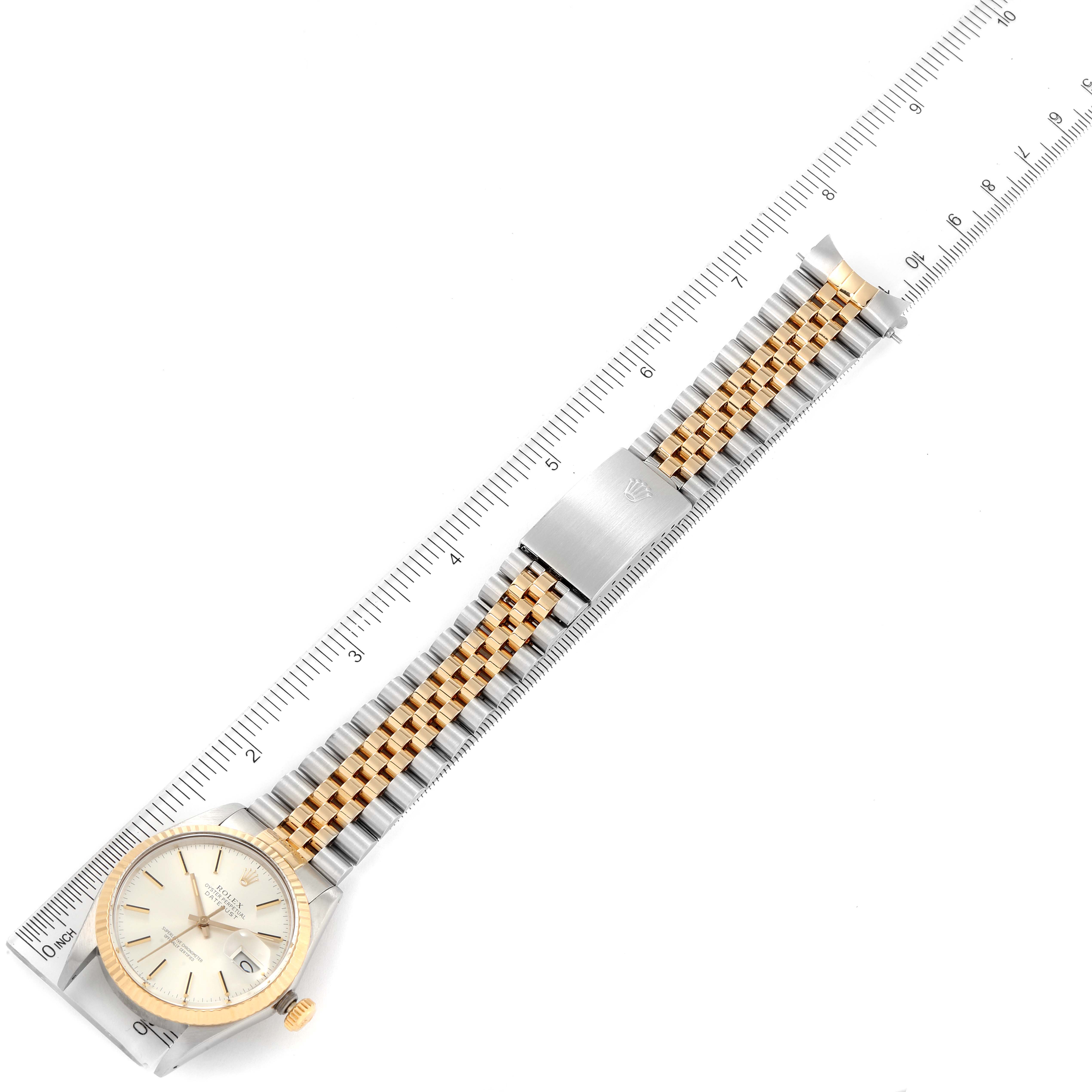 The Vintage Collection Rolex watch is shown from a top-down angle, displaying the face, bezel, and full bracelet.