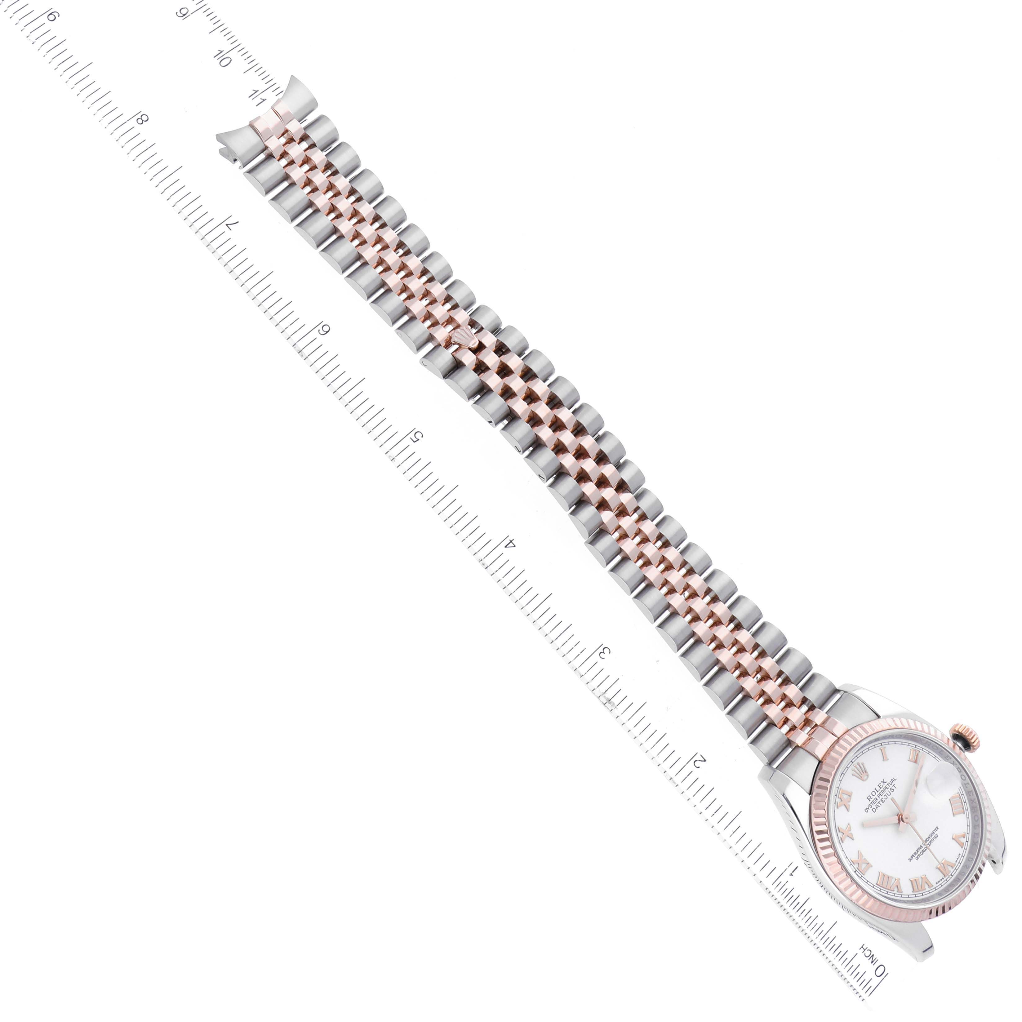 The Rolex Datejust 116231 Men's Steel and Gold (two tone) White Dial 116231 Men's Steel and Gold (two tone) White Dial watch is shown at an angled view, displaying its dial, fluted bezel, and jubilee bracelet, alongside a ruler for scale.