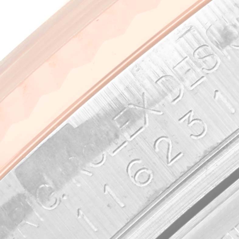This close-up angled shot shows the engraved serial number and "ROLEX" text on the case of a Rolex Datejust 116231 Men's Steel and Gold (two tone) White Dial 116231 Men's Steel and Gold (two tone) White Dial watch.