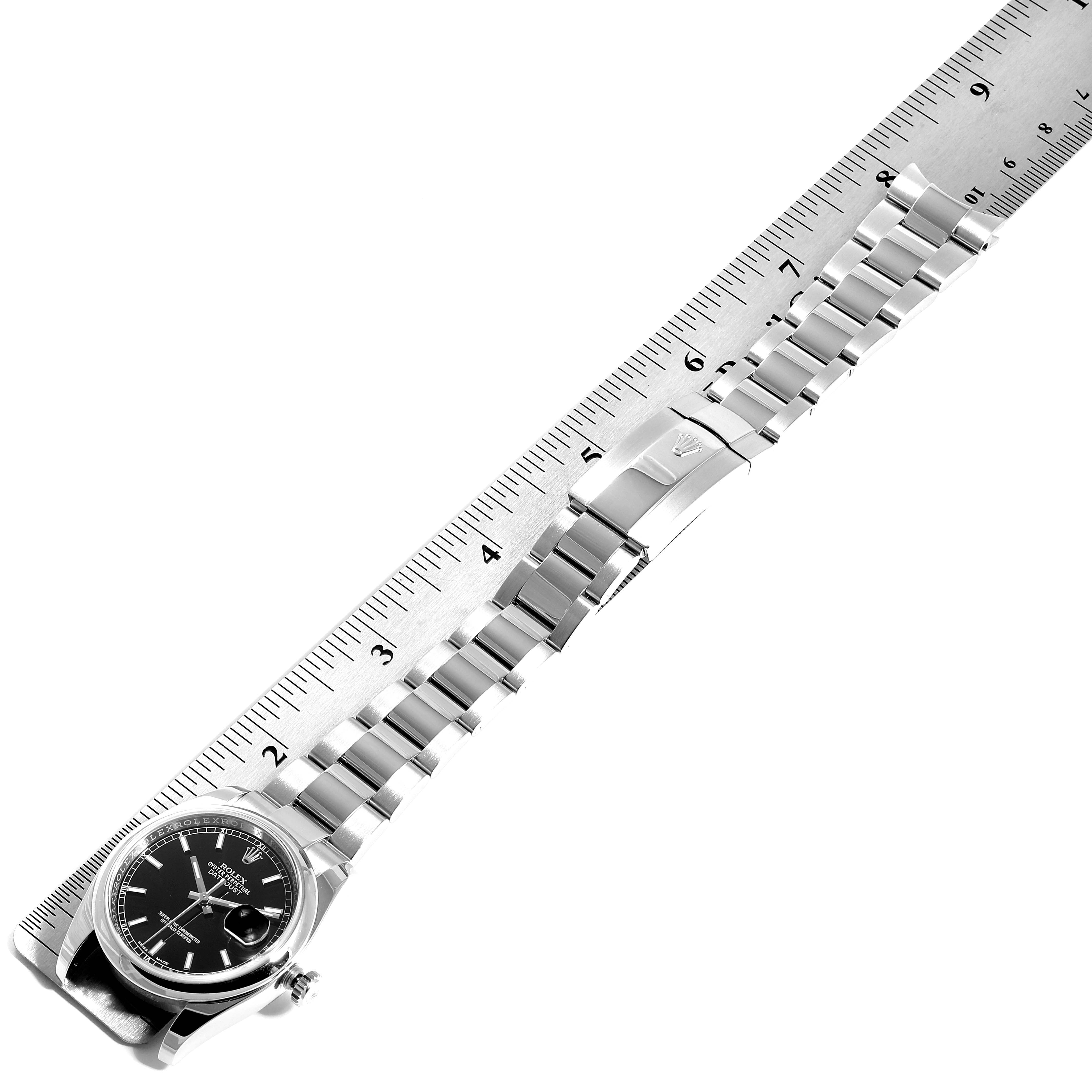 The image shows a Rolex Datejust 116200  Men's Stainless Steel Black Dial 116200  Men's Stainless Steel Black Dial watch and its bracelet measured against a ruler, highlighting the band and clasp.