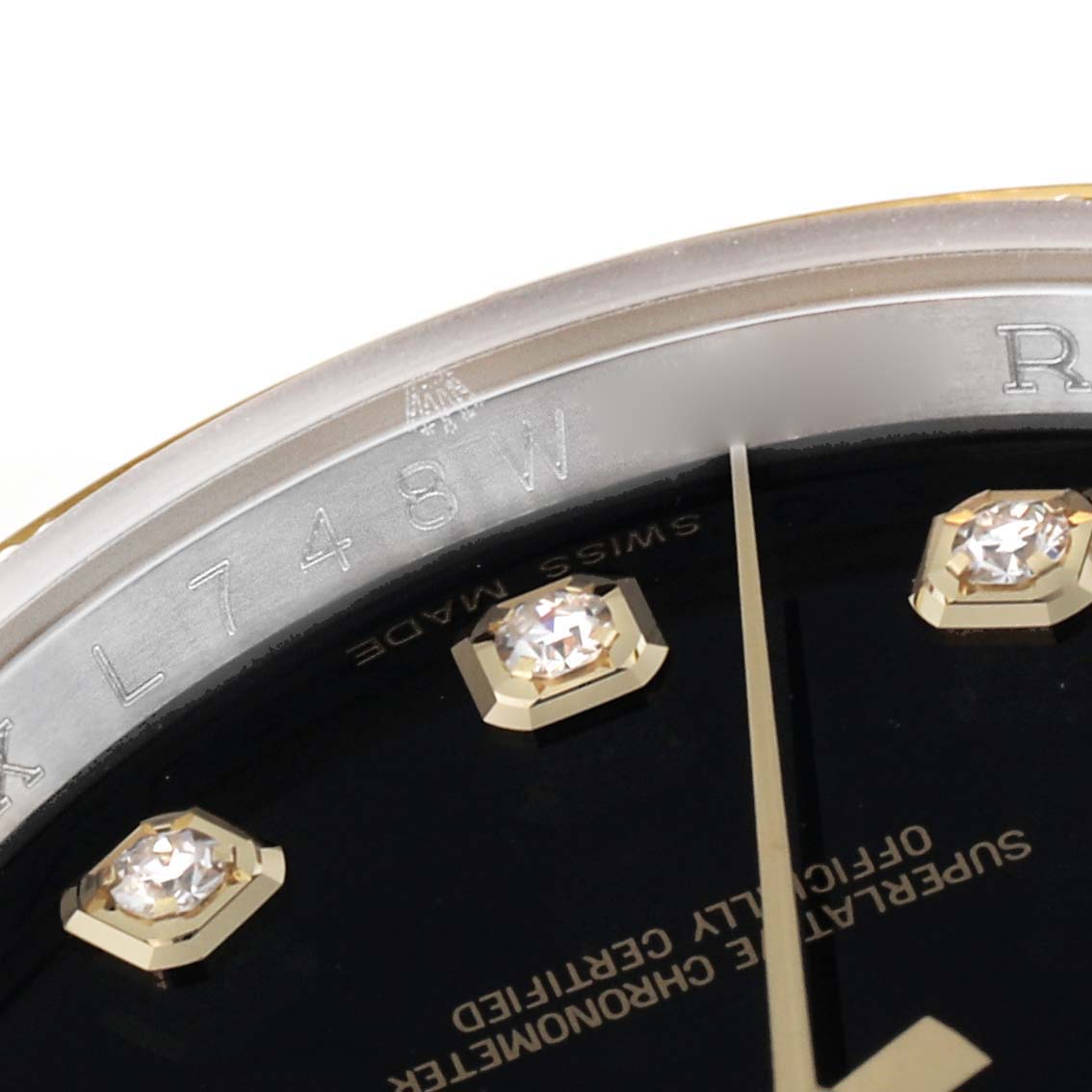 This image shows a close-up of the dial and part of the bezel of a Rolex Datejust 116243 Men's Steel and Gold (two tone) Black Dial 116243 Men's Steel and Gold (two tone) Black Dial watch, featuring diamond markers.