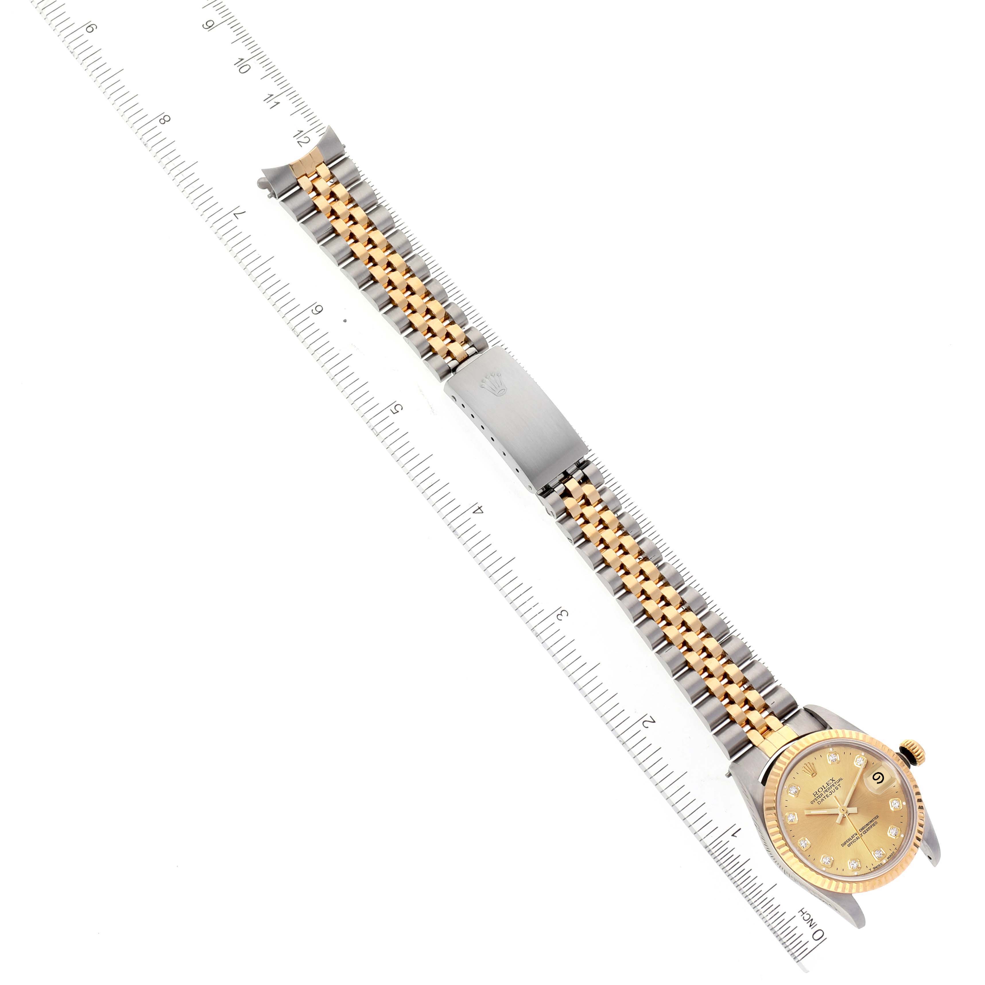 This image shows the full length of a Rolex Mid-Size 68273 Women
s Steel and Gold (two tone) Champagne Dial 68273 Women
s Steel and Gold (two tone) Champagne Dial watch laid flat with its band, face, and clasp visible.