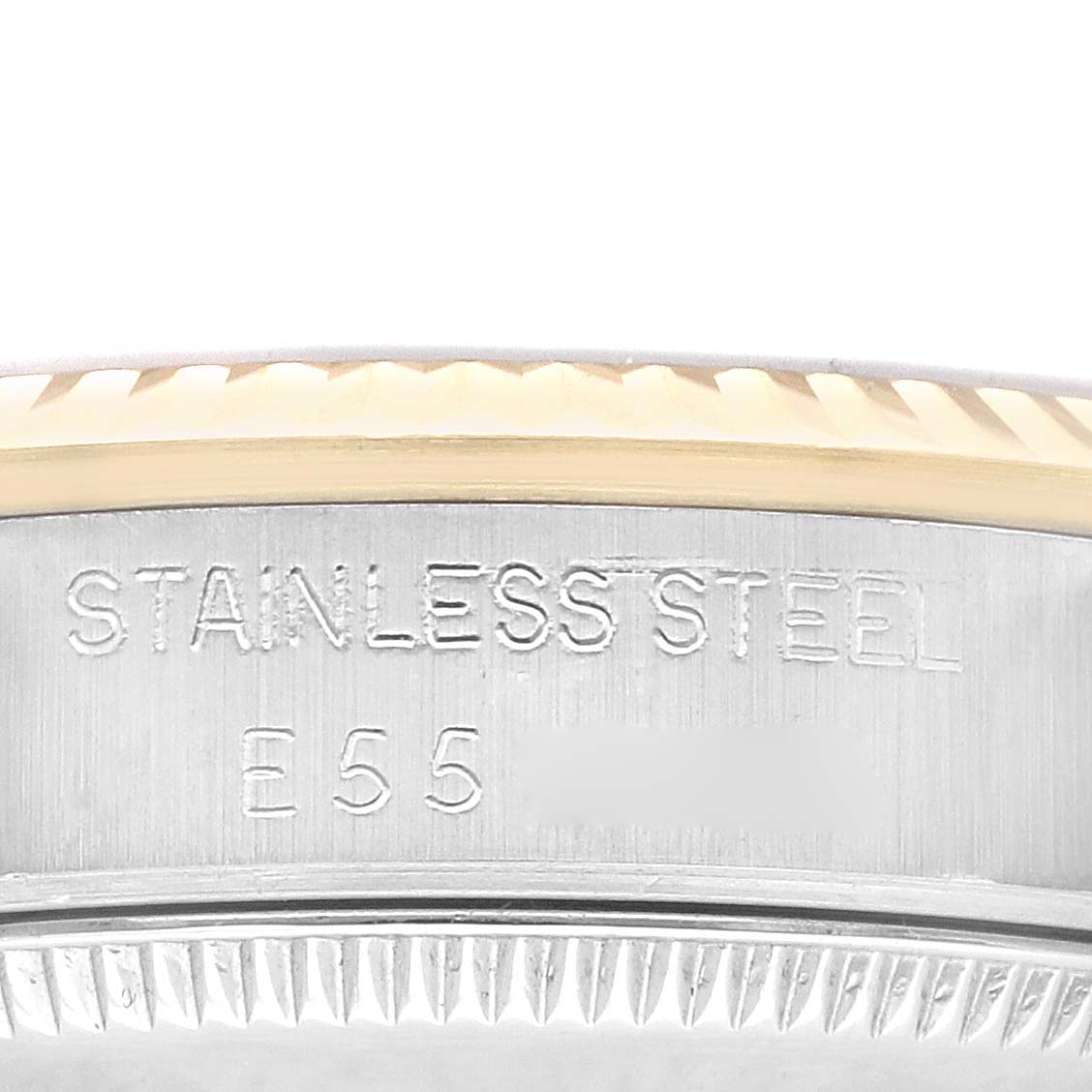 This close-up image of the Rolex Mid-Size 68273 Women's Steel and Gold (two tone) Champagne Dial 68273 Women's Steel and Gold (two tone) Champagne Dial model shows the stainless steel engravings on the case with a partial view of the bezel.