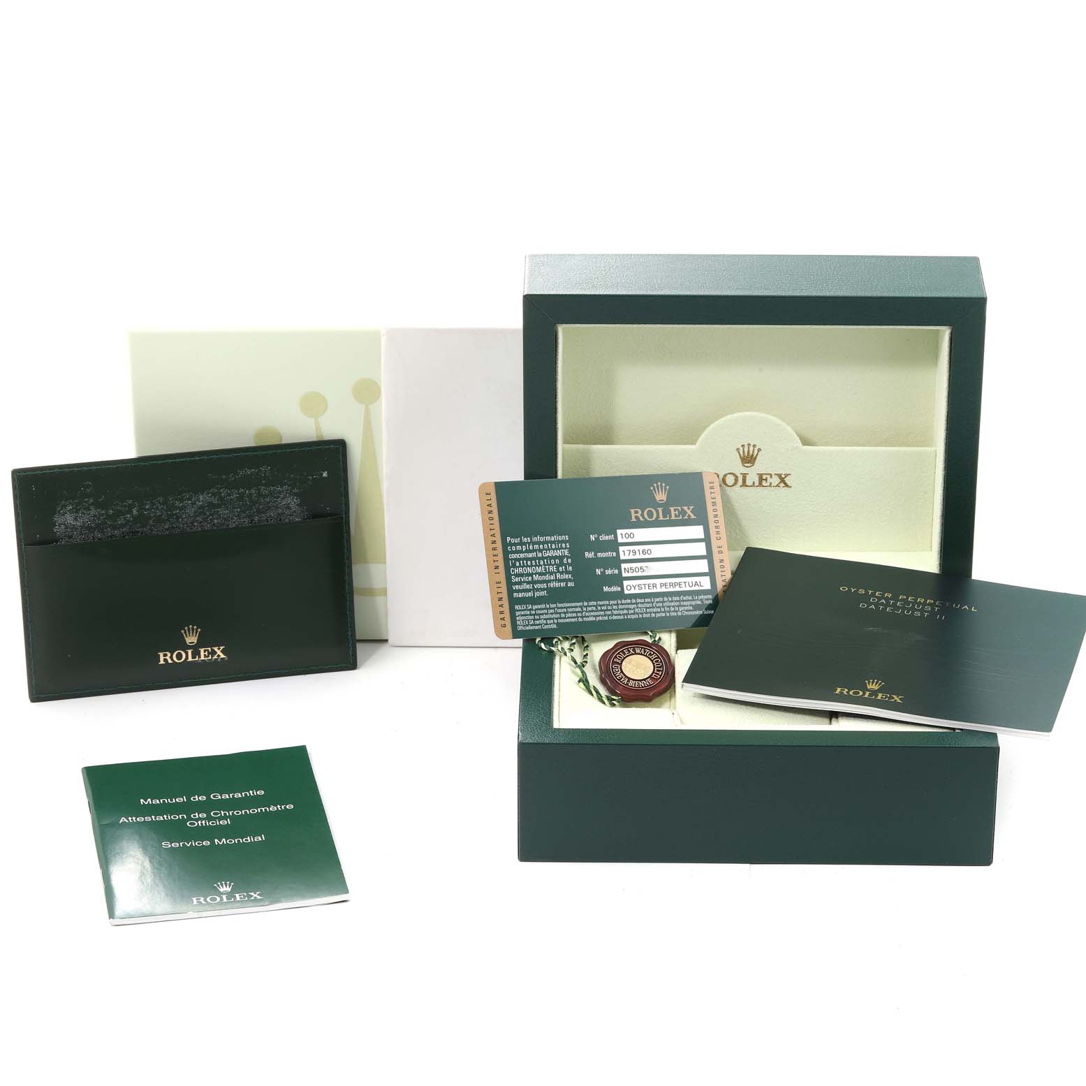 This image shows the packaging and accessories for a Rolex Datejust 179160 Women's Stainless Steel Pink Dial 179160 Women's Stainless Steel Pink Dial, including manuals, warranty card, and the box.