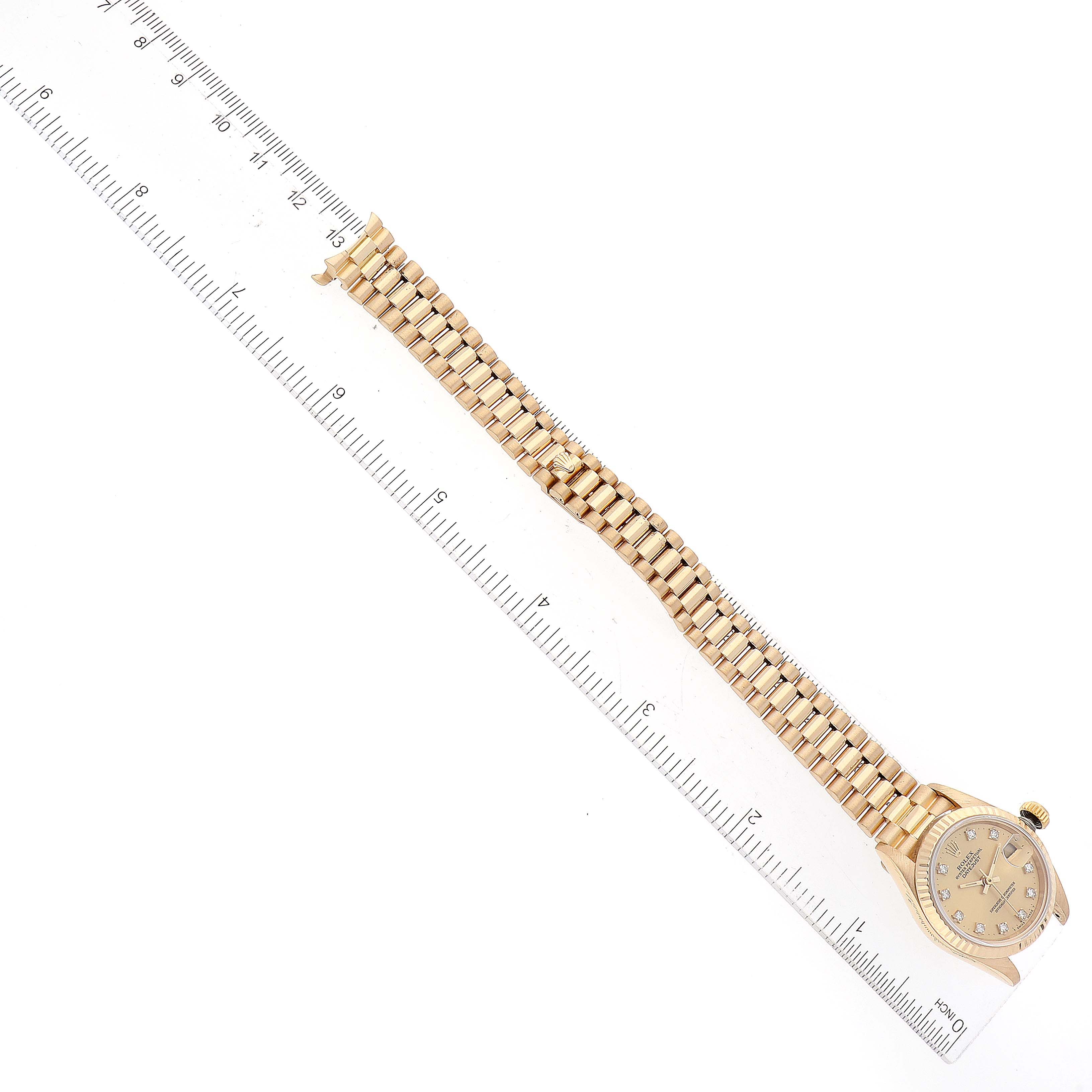 The image shows a Rolex President 69178 Women's Yellow Gold Champagne Dial 69178 Women's Yellow Gold Champagne Dial model watch from a top-down angle, focusing on the band's length against a ruler for scale.
