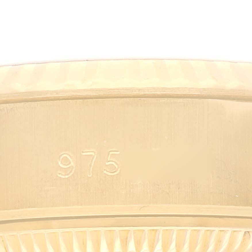 The image shows a close-up of the side of a Rolex President 69178 Women's Yellow Gold Champagne Dial 69178 Women's Yellow Gold Champagne Dial model watch, highlighting the engraved "975" marking.