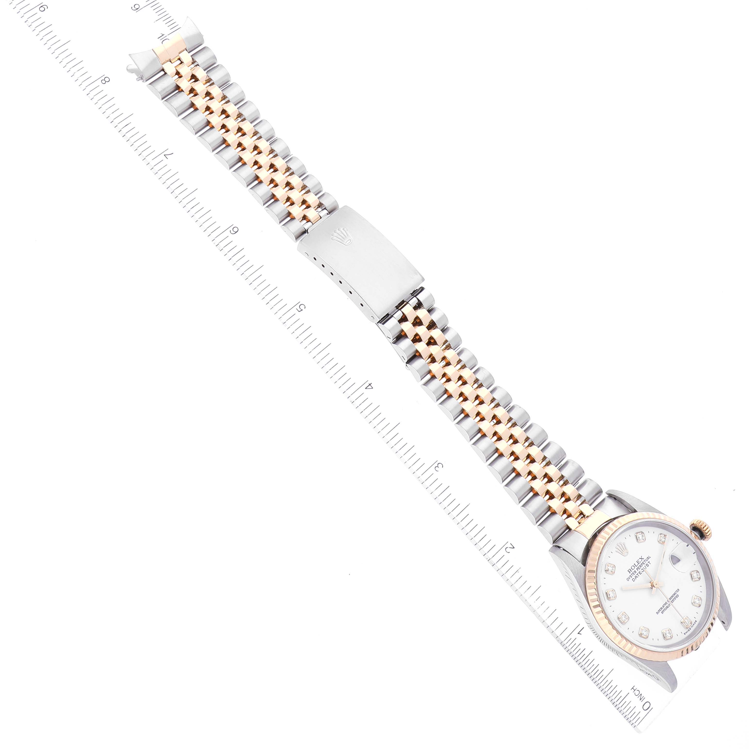 The image shows an overhead view of a Rolex Datejust 16233 Men's Steel and Gold (two tone) White Dial 16233 Men's Steel and Gold (two tone) White Dial watch with a two-tone jubilee bracelet and clasp.