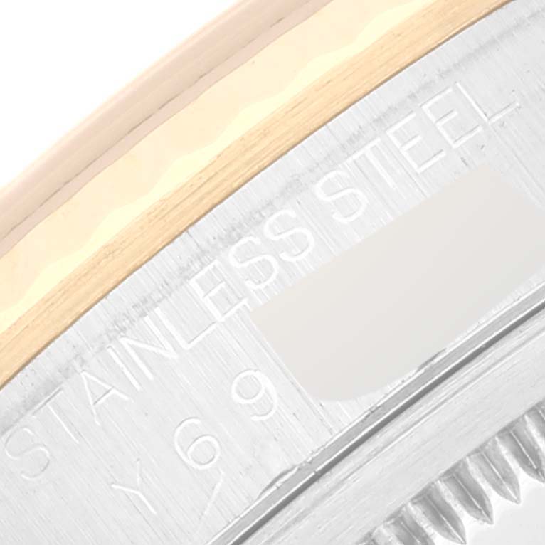 This close-up image of the Rolex Datejust 16233 Men's Steel and Gold (two tone) White Dial 16233 Men's Steel and Gold (two tone) White Dial watch shows partial engravings on its stainless steel case edge.