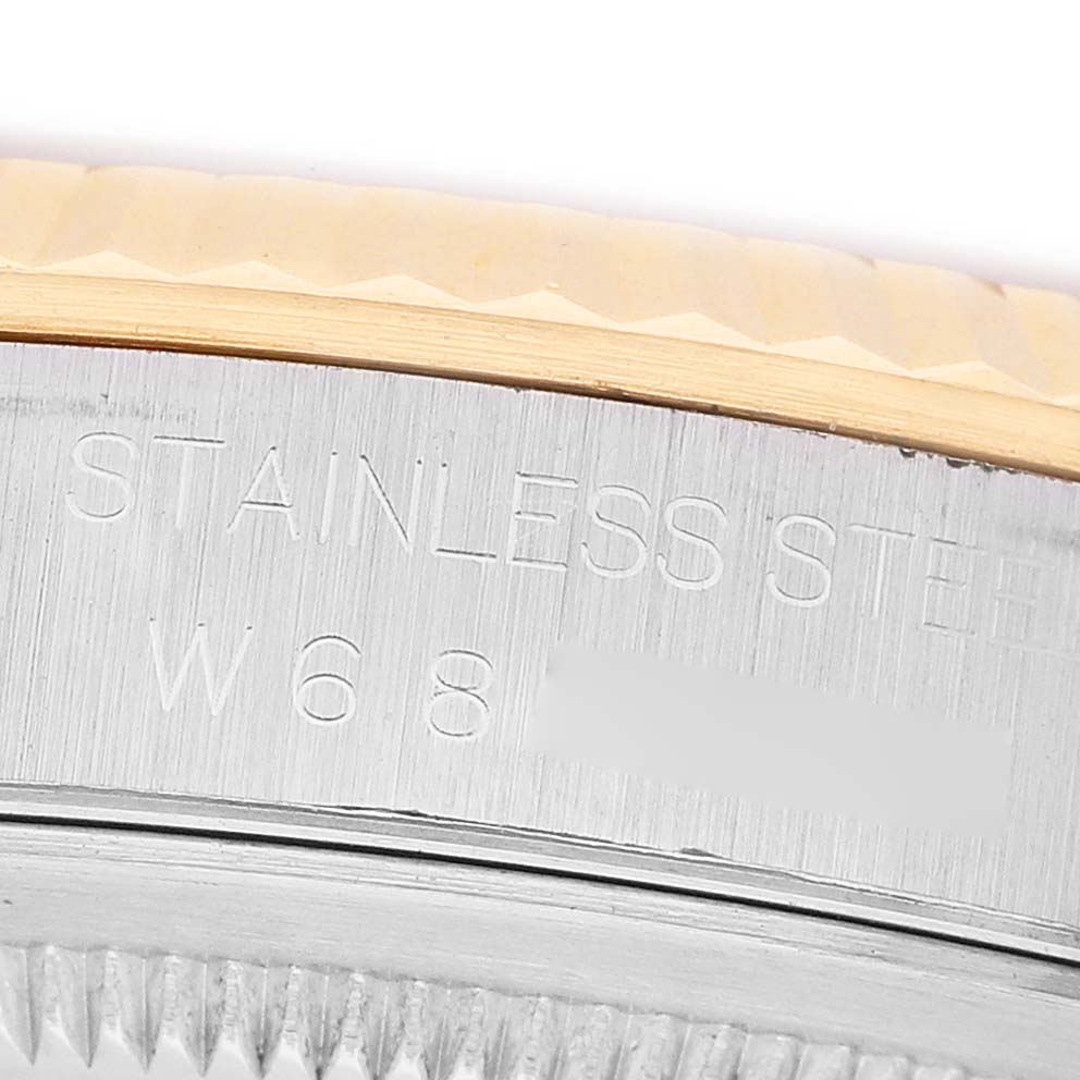 The image shows a close-up of the side of a Rolex Datejust 16233 Men's Steel and Gold (two tone) Champagne Dial watch, focusing on the stainless steel engraving near the bezel.