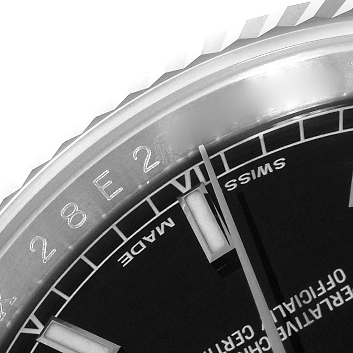 This close-up image of a Rolex Datejust 116234 Men
s Stainless Steel Black Dial 116234 Men
s Stainless Steel Black Dial watch shows part of its bezel, the edge of the dial, and hour markers.
