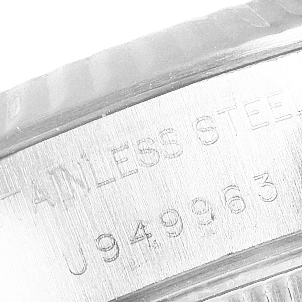 This is a close-up image of the engraved side of a Rolex Datejust 69174 Women
s Stainless Steel Silver Dial 69174 Women
s Stainless Steel Silver Dial watch showing "STAINLESS STEEL" and serial number.