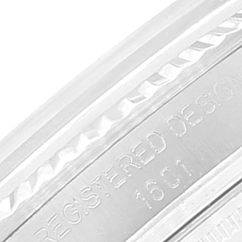 This is a close-up shot of the side of a Rolex Vintage Collection 1601 Men's Stainless Steel Silver Dial 1601 Men's Stainless Steel Silver Dial watch, showing part of the bezel and engraved text.