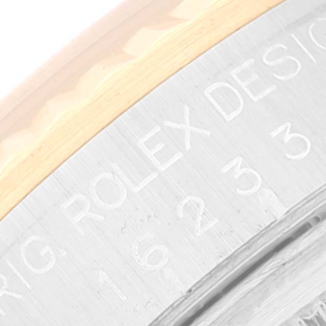 This image shows a close-up of the case back and edge of a Rolex Datejust 16233 Men's Steel and Gold (two tone) Black Dial 16233 Men's Steel and Gold (two tone) Black Dial watch, displaying the engraved writing.