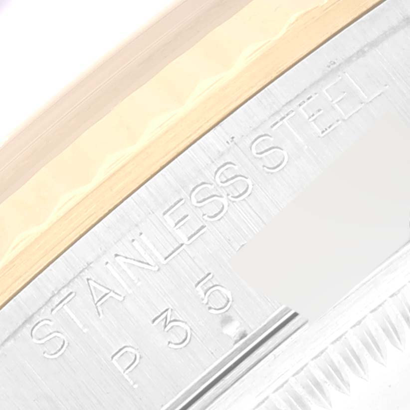 The image shows a close-up angle of the Rolex Datejust 16233 Men's Steel and Gold (two tone) Black Dial 16233 Men's Steel and Gold (two tone) Black Dial watch's stainless steel case with engraved text.