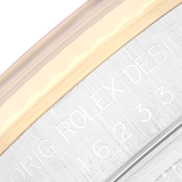 This image shows a close-up of the engraving on the outer rim of the back case of a Rolex Datejust 16233 Men's Steel and Gold (two tone) Black Dial 16233 Men's Steel and Gold (two tone) Black Dial watch.
