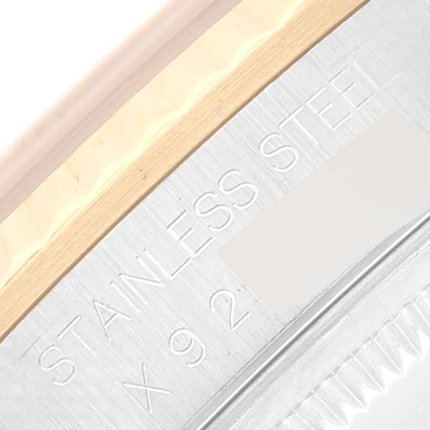 This close-up image shows part of the bezel and the engraved "STAINLESS STEEL" marking of the Rolex Datejust 16233 Men's Steel and Gold (two tone) Black Dial 16233 Men's Steel and Gold (two tone) Black Dial watch.