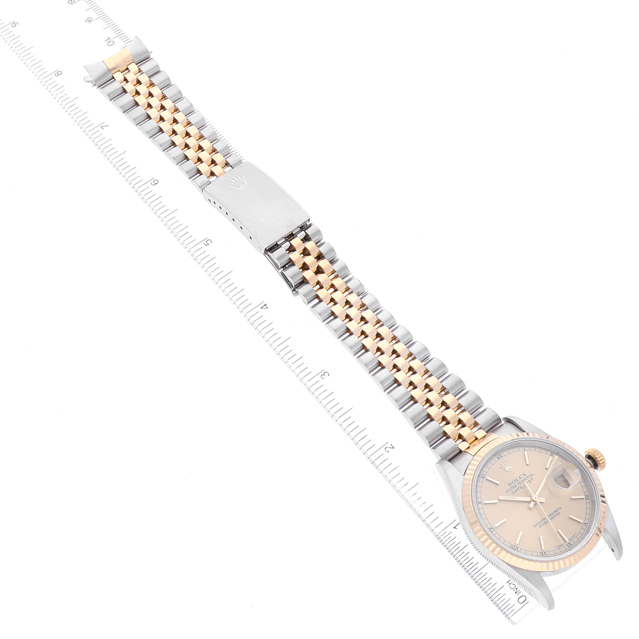 The Rolex Datejust 16233 Men's Steel and Gold (two tone) Champagne Dial 16233 Men's Steel and Gold (two tone) Champagne Dial watch is shown in a flat lay angle, displaying the entire watch face and two-tone bracelet band.