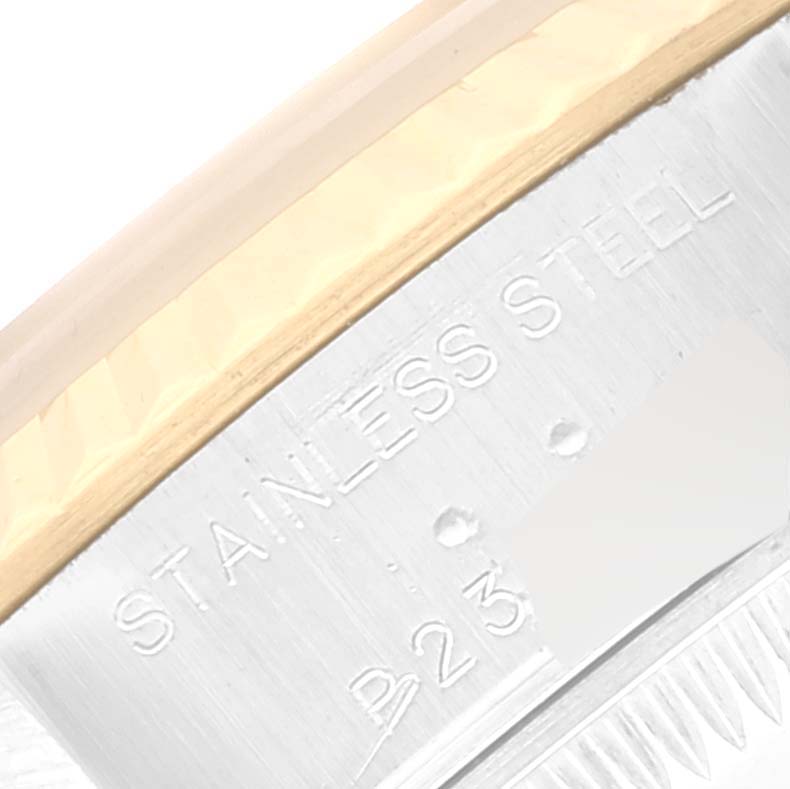 This is a close-up angle of the Rolex Datejust 79173 Women's Steel and Gold (two tone) Blue Dial 79173 Women's Steel and Gold (two tone) Blue Dial model, showing the part of the case with "STAINLESS STEEL" engraved.