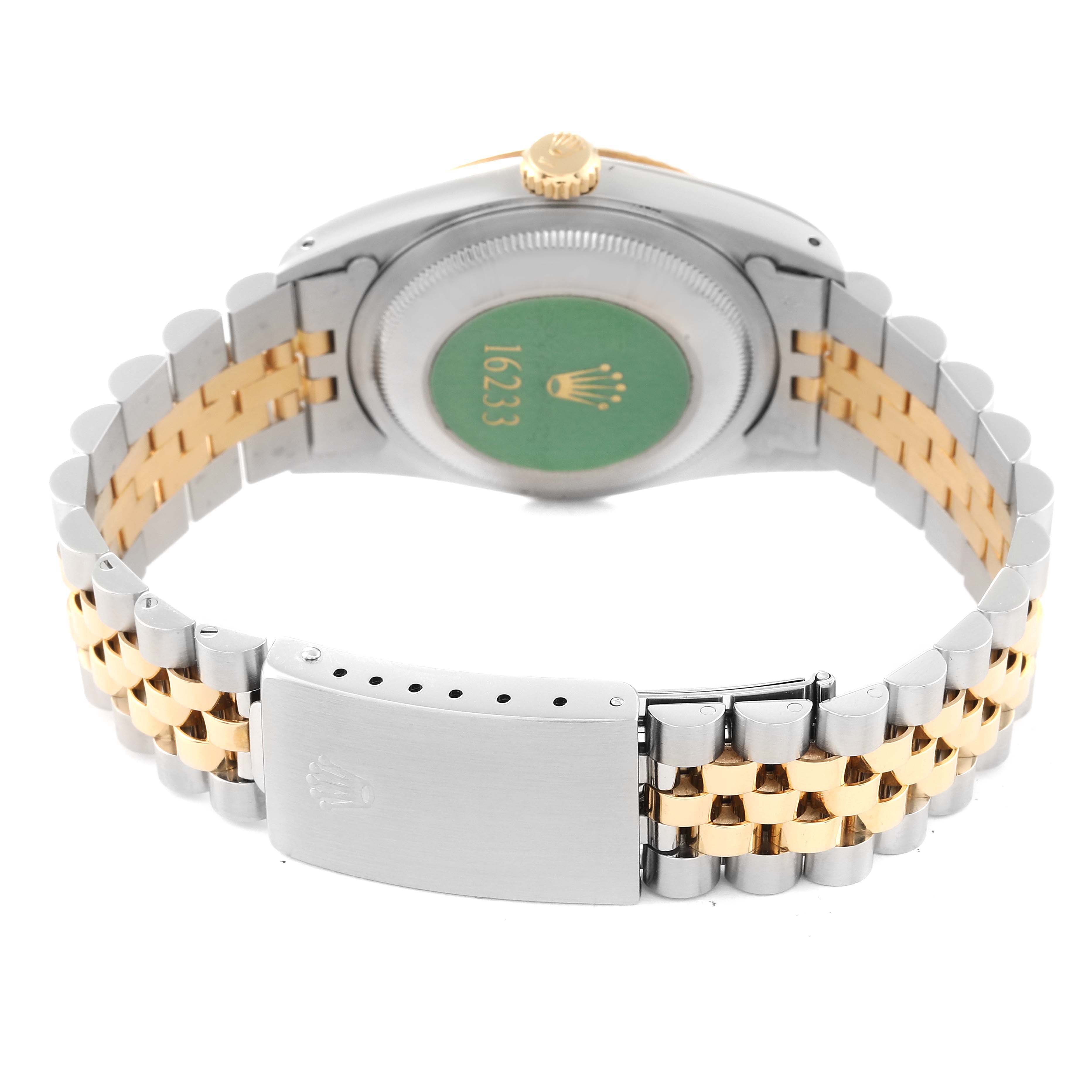 The image shows the backside of a Rolex Datejust 16233 Men's Steel and Gold (two tone) Champagne Dial 16233 Men's Steel and Gold (two tone) Champagne Dial watch, emphasizing its case back and two-tone bracelet clasp.