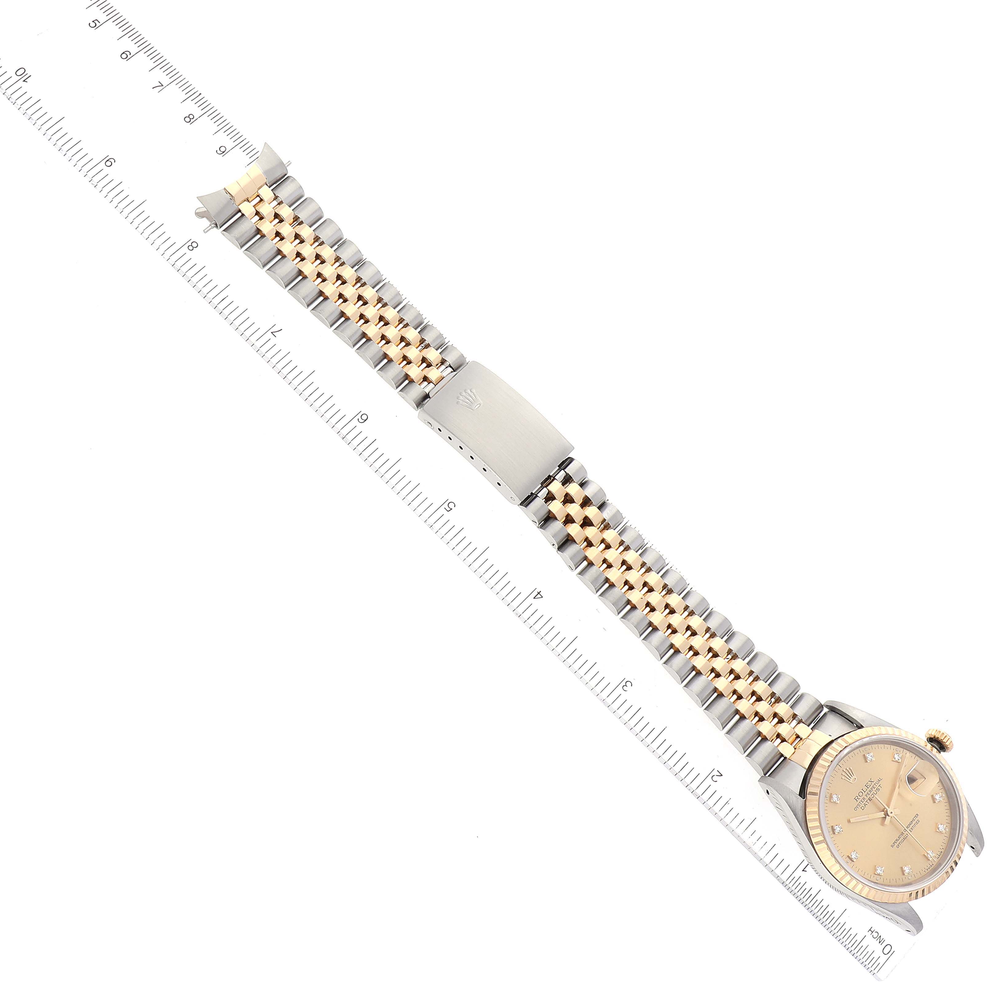The image shows a Rolex Datejust 16233 Men's Steel and Gold (two tone) Champagne Dial 16233 Men's Steel and Gold (two tone) Champagne Dial watch laid flat with a clear view of the face and jubilee bracelet alongside a ruler for measurement.