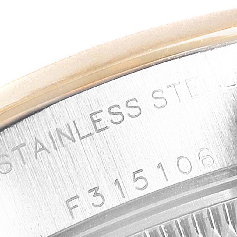 This image shows a close-up of the case back of the Rolex Datejust 79163  Women
s Steel and Gold (two tone) Grey Dial 79163  Women
s Steel and Gold (two tone) Grey Dial, highlighting the stainless steel text and serial number.