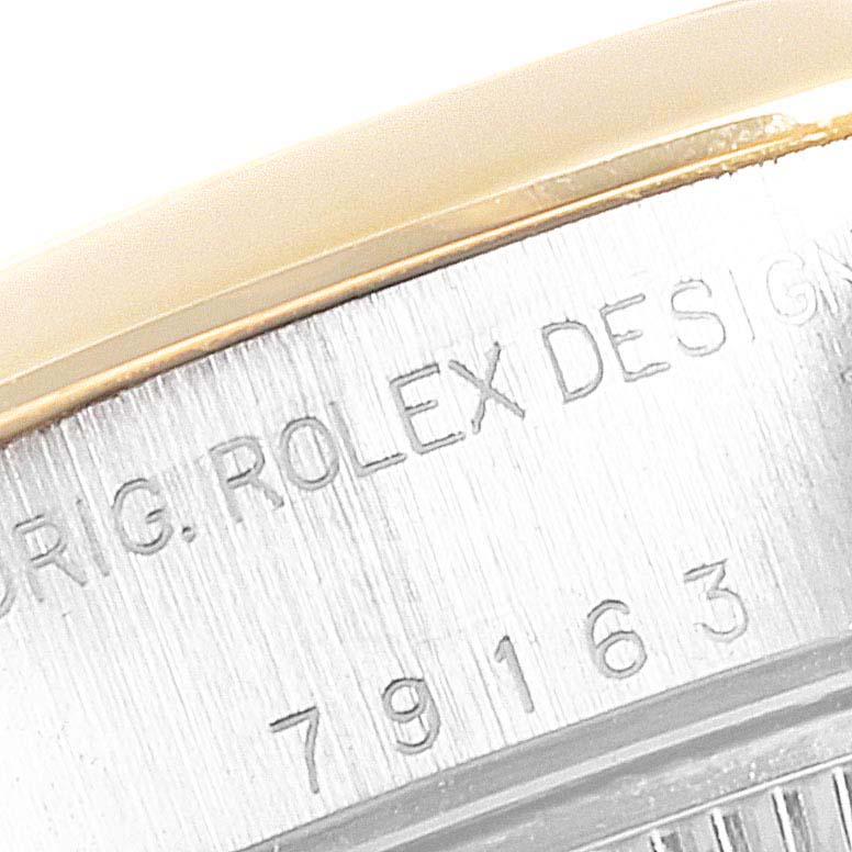 The image shows a close-up of the case side with engravings from a Rolex Datejust 79163  Women
s Steel and Gold (two tone) Grey Dial 79163  Women
s Steel and Gold (two tone) Grey Dial watch, including model details and branding.
