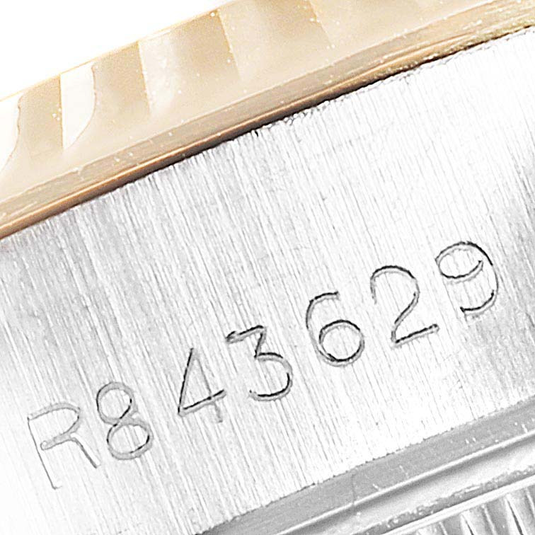 The image shows a close-up of the serial number engraving on the side of a Rolex Datejust 69173 Women
s Steel and Gold (two tone) Champagne Dial 69173 Women
s Steel and Gold (two tone) Champagne Dial watch.
