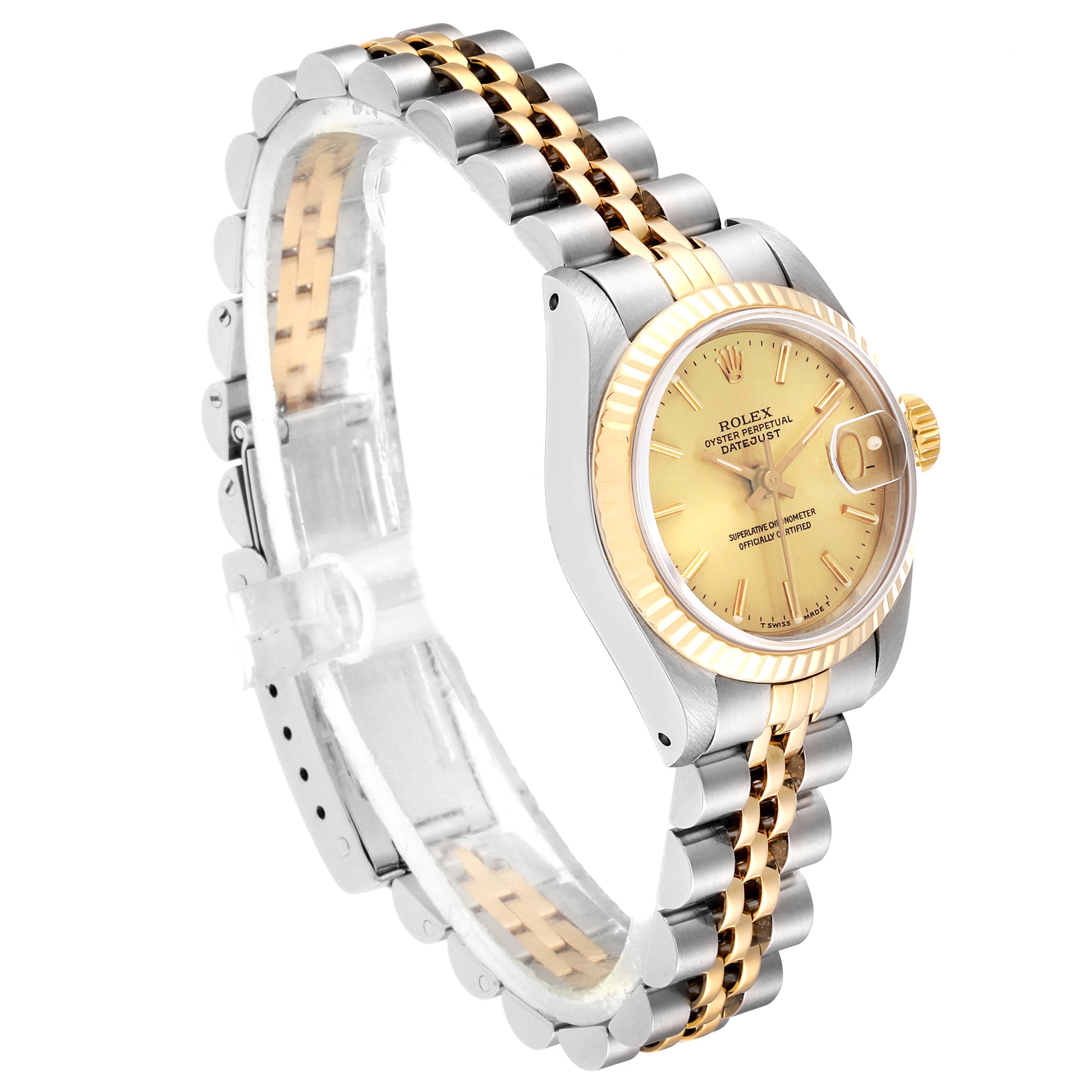 The Rolex Datejust 69173 Women
s Steel and Gold (two tone) Champagne Dial 69173 Women
s Steel and Gold (two tone) Champagne Dial model watch is shown at a slight angle, highlighting its golden dial, fluted bezel, and two-tone bracelet.