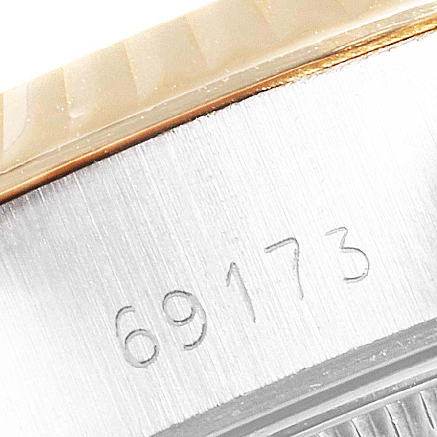 The image shows a close-up angle of the side of a Rolex Datejust 69173 Women
s Steel and Gold (two tone) Champagne Dial 69173 Women
s Steel and Gold (two tone) Champagne Dial watch, displaying its model number 69173.